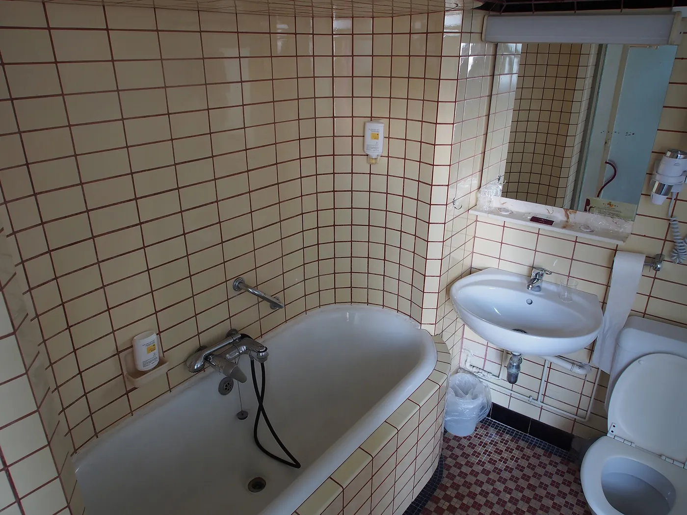 Before: dated bathroom with small wall tiles and old fittings, Karen