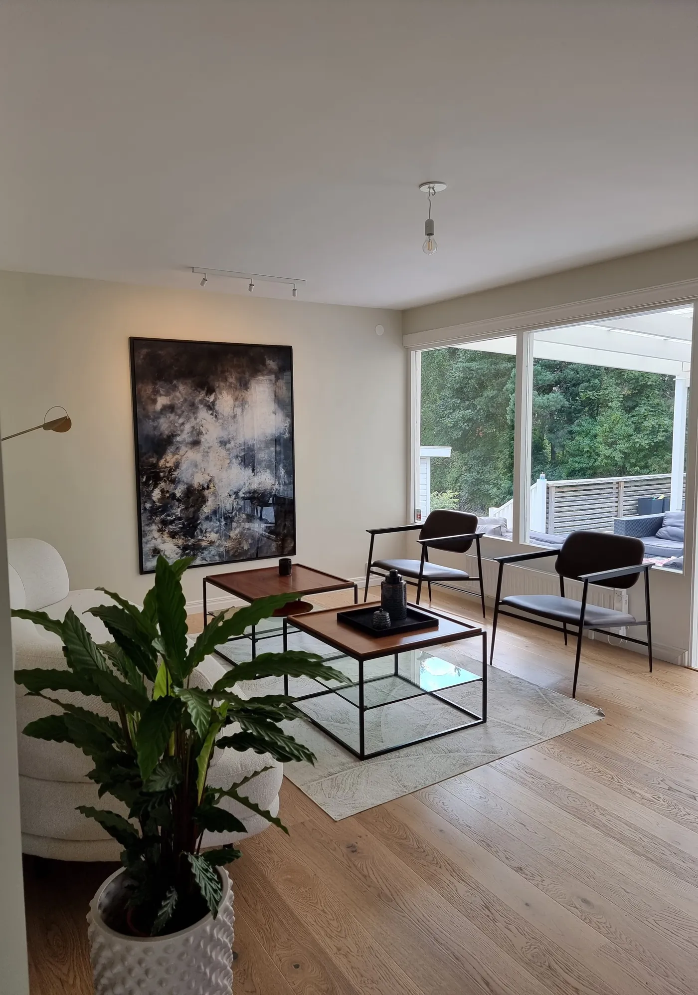Living room corner with plants and framed prints after styling