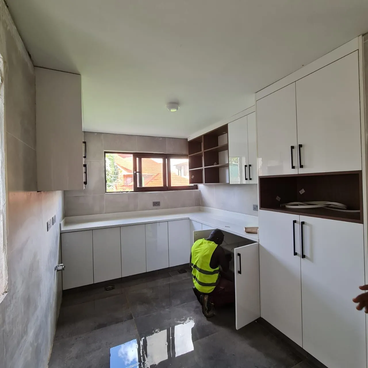 Before: kitchen during strip-out and refit with base units being installed, Kilimani