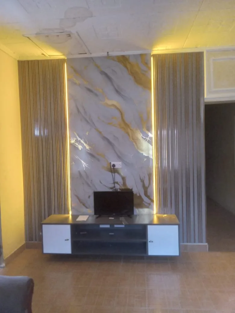 Marble TV feature wall with gold accent lighting and fluted side panels