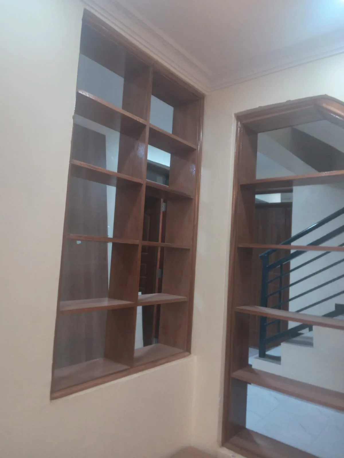 Wooden shelf niche built into a staircase landing