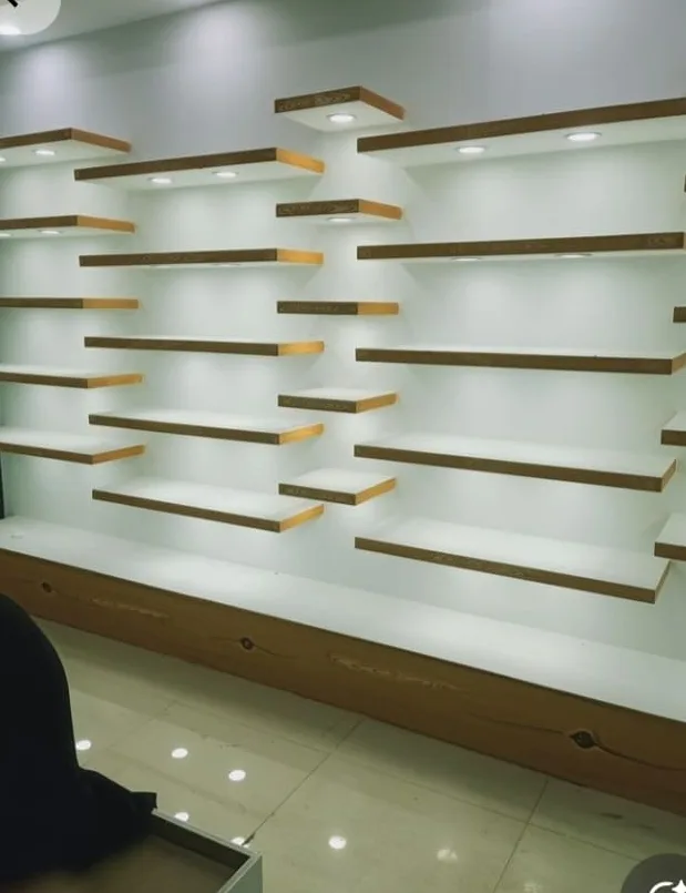 Floating display shelves with LED lighting on a store wall
