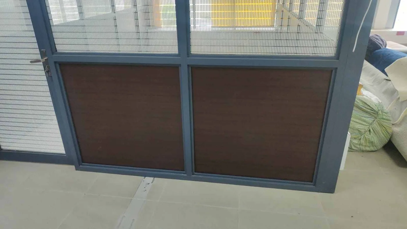 Close-up of wood and glass office partition with window blinds