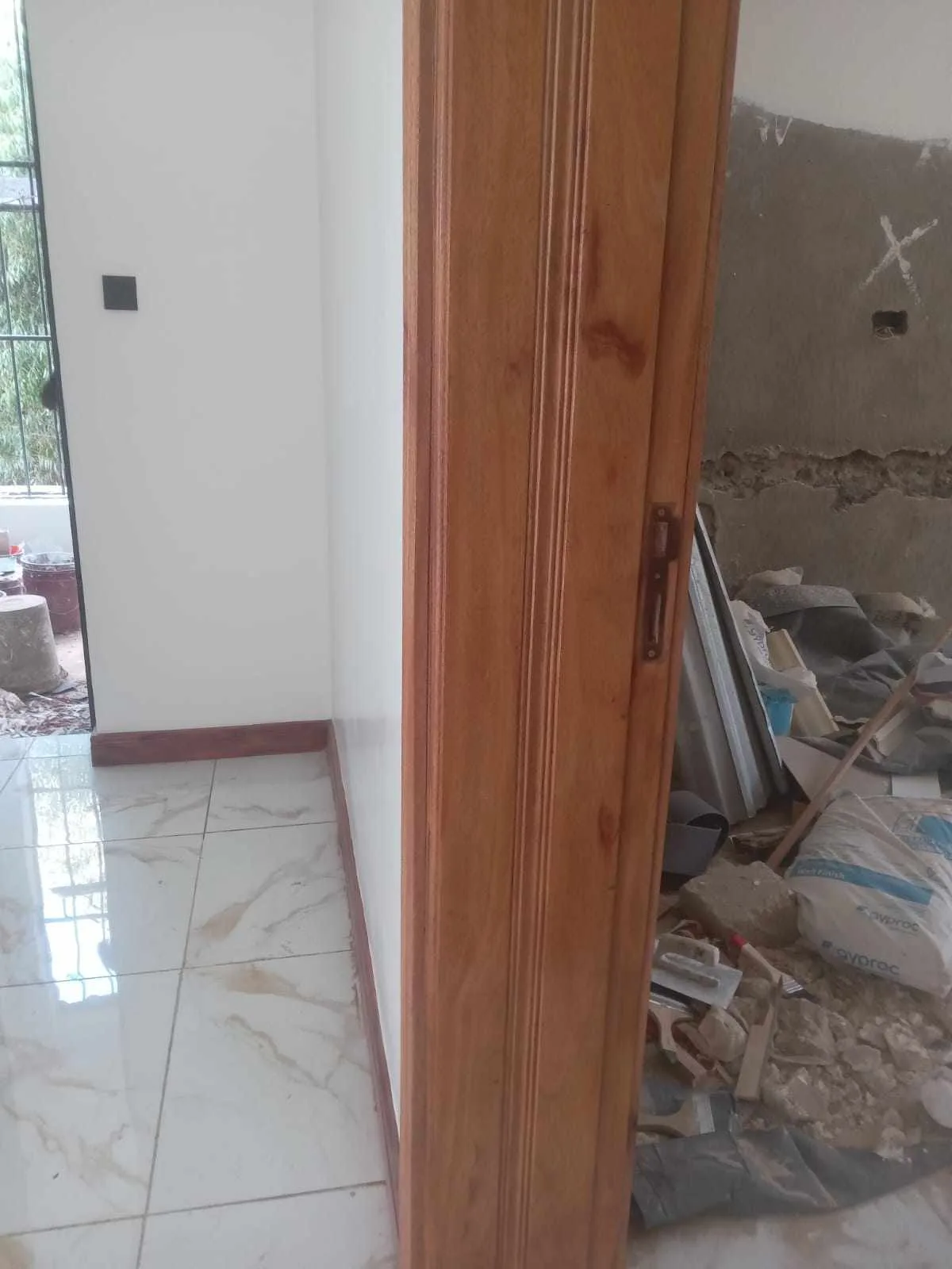 Panelled doors and fitted joinery along a Nairobi apartment corridor