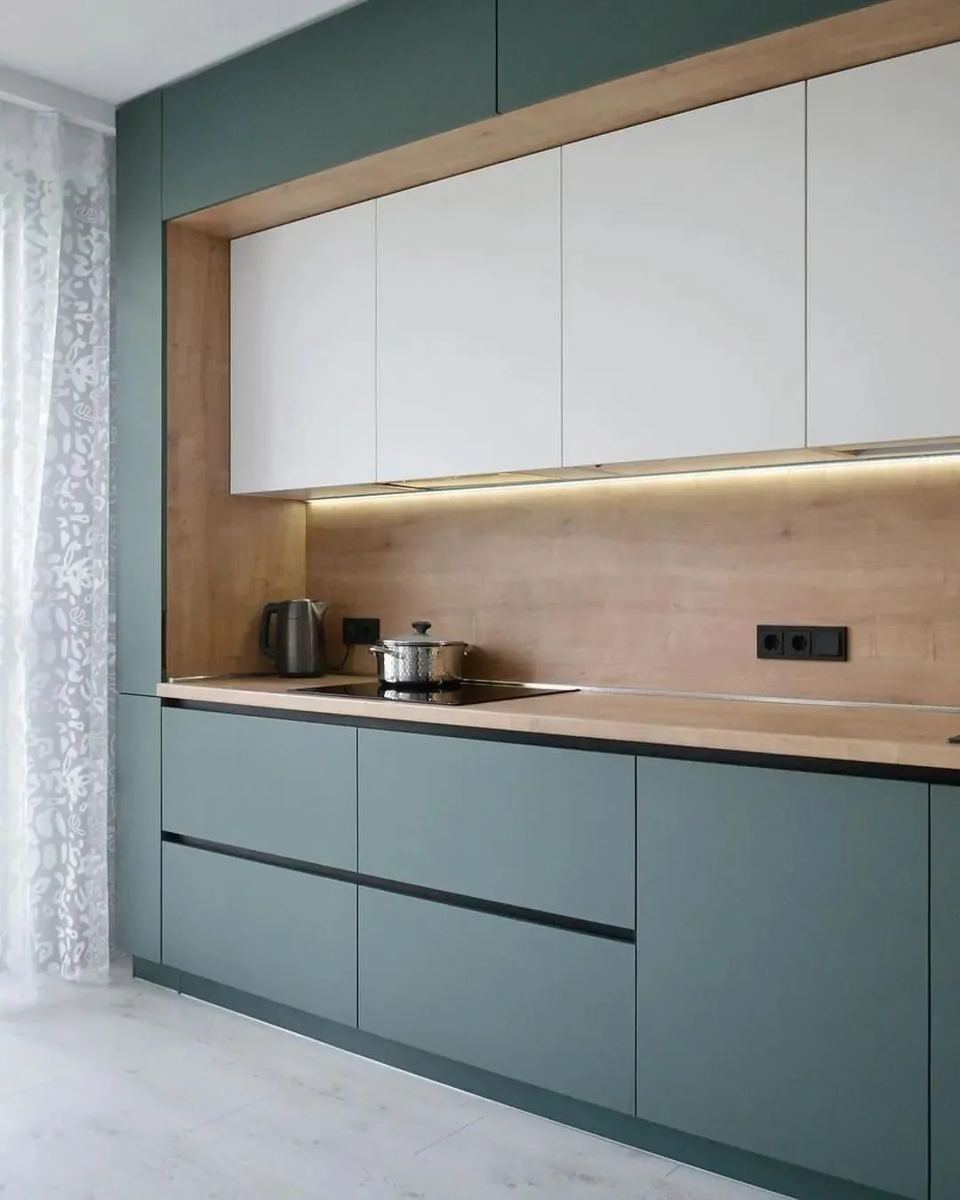 Sage green and white fitted kitchen with timber splashback, Nairobi