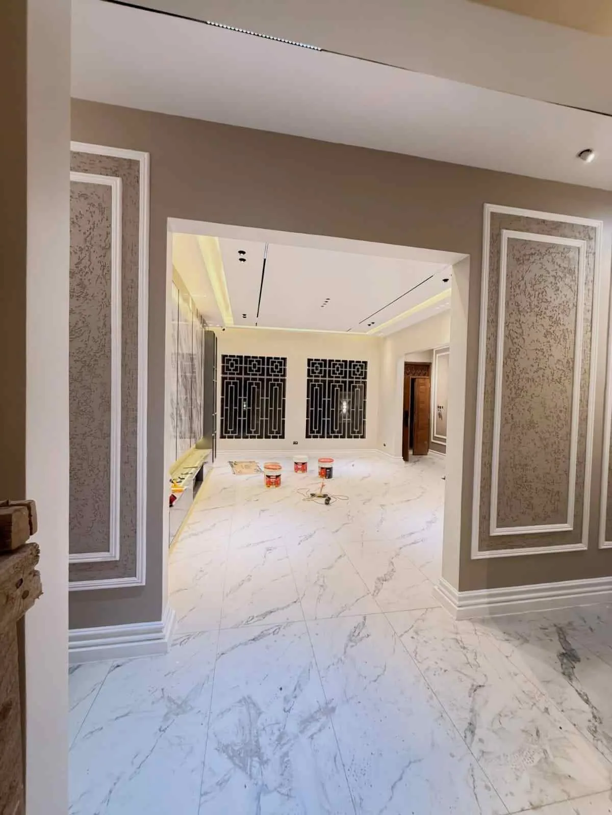 Classical wall panelling and feature wall with chandelier, Nairobi home