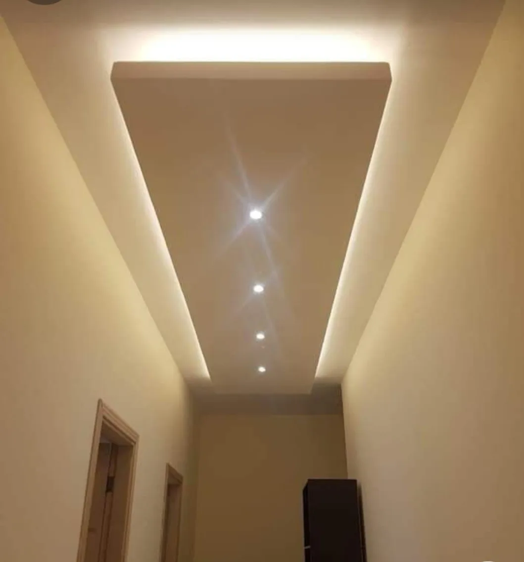Panelled ceiling with recessed sections and spotlights in a Nairobi interior