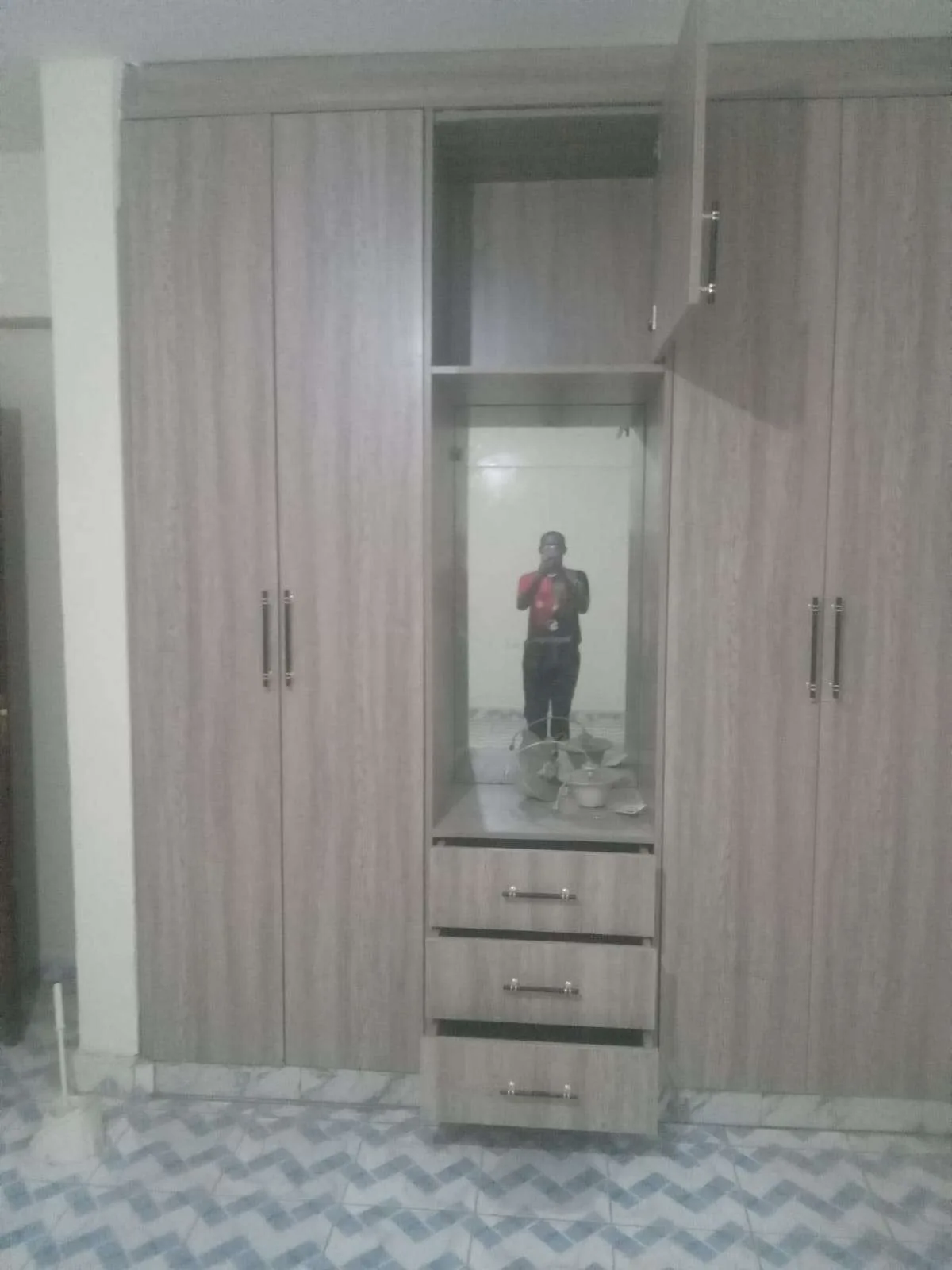 Walk-in wardrobe with oak shelving, drawers and LED strip lighting, Nairobi